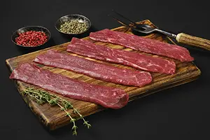 Black Background Food Drucke: Raw beef strips on black background