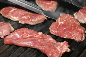 Gourmet Grilled Meat Drucke: Raw steak on the grill