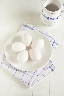 Easter Egg Photography Drucke: Raw white eggs lay on a plate
