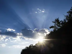 Empty Austrian Landscapes Drucke: Rays of sunshine breaking through clouds
