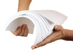 Copy Space Image Drucke: Ream in his hand isolated on white background