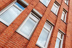 Cloudy Sky Reflections Drucke: Red brick building wall with clouds reflections in windows