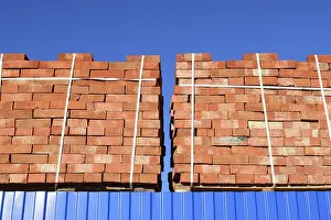 Industrial Building Materials Drucke: Red bricks stacked into cubes. Warehouse bricks