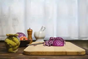 Raw Food Nutrition Drucke: Red cabbage and ingredients for salad on kitchen table
