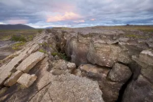 Atmospheric Landscape Photography Drucke: Red column in the plain with dramatic clouds in the evening sky in the fault zone