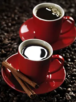 Coffee Bean Background Drucke: Two red cups of coffee on coffe beans background