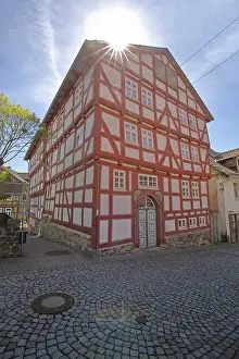 Historic Quarter Germany Drucke: Red frame house with back light