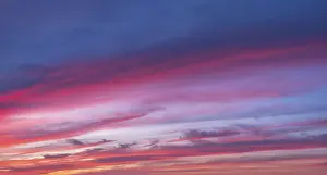 Cloudy Evening Light Drucke: Red glowing clouds in the evening light at sunset