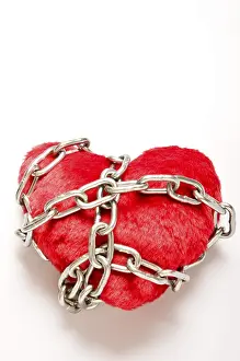 Symbolic Love Concept Image Drucke: A red plush heart wrapped in chains
