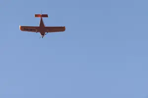 German Air Traffic Control Drucke: Red small aeroplane flying in a cloudless sky