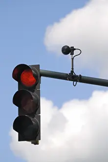 Cloudy Sky Background Drucke: Red traffic light with sensor against cloudy sky