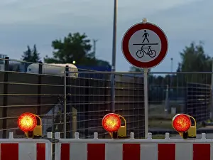 Deserted German Street Scene Drucke: Red warning lights and warning barriers
