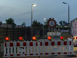 Deserted German Street Scene Drucke: Red warning lights and warning barriers