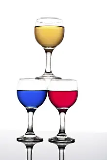 Red, yellow and blue backlit drinks with reflection