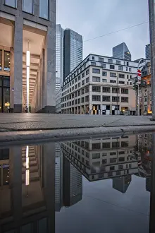 Urban Office Space Drucke: Reflection in a puddle between skyscrapers