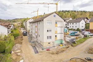 Residential Construction Germany Drucke: A residential development under construction with cranes in the background