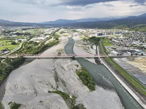 Abandoned Urban Environment Drucke: A river with a bridge over it and a city in the background