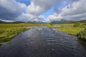 Cloudy Sky Over Scotland Drucke: River flows through green landscape under sky with clouds