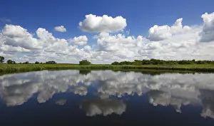 UNESCO Biosphere Reserve Elbe River Drucke: River Sude with cloudy skies, reflection