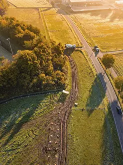 Atmospheric Autumn Mood Photo Drucke: Road through fields with construction