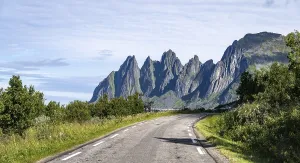 Senja Island Norway Drucke: Road, behind rocky peak Devil's Teeth