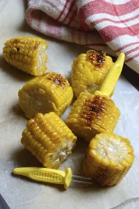 Corn Still Life Photography Drucke: Roasted corn on the corn cob with corn on the cob holder