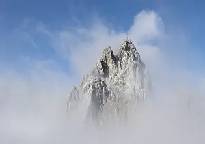 Cloudy Mountain Range Drucke: Rocky mountain peak between clouds
