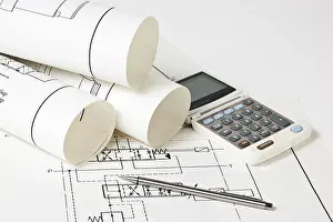 Empty Construction Site Drucke: Rolled technical drawings and a calculator