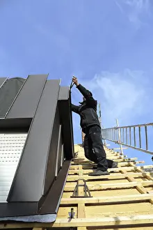 Residential Building Roofing Drucke: Roofer working on a new dormer window