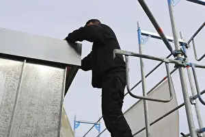 Construction Site Worker Drucke: Roofer working on a new dormer window