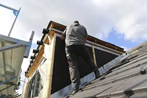 Construction Site Worker Drucke: Roofer working on a new dormer window