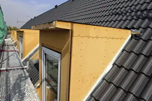 Stainless Steel Roofing Materials Drucke: Roofer working on a new dormer window