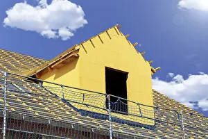 Construction Site Worker Drucke: Roofer working on a new dormer window