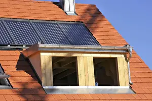 Construction Site Worker Drucke: Roofer working on a new dormer window
