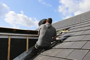 Roof Construction Drucke: Roofer working on a new dormer window