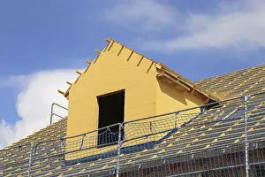 Construction Site Worker Drucke: Roofer working on a new dormer window