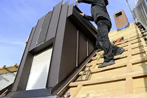 Stainless Steel Roofing Materials Drucke: Roofer working on a new dormer window