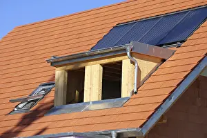 Stainless Steel Roofing Materials Drucke: Roofer working on a new dormer window