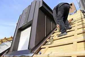 New Roof Installation Drucke: Roofer working on a new dormer window