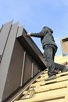 Stainless Steel Roofing Materials Drucke: Roofer working on a new dormer window