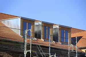 Roofer At Work Drucke: Roofer working on a new dormer window