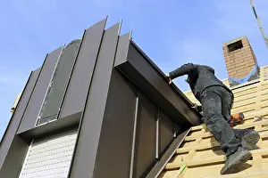 Construction Site Worker Drucke: Roofer working on a new dormer window