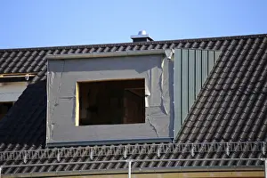 Construction Site Worker Drucke: Roofer working on a new dormer window