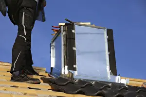 Residential Building Renovation Drucke: Roofer works on the chimney cladding