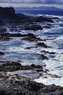 Rocky Coast Of Spain Drucke: Rough sea with waves hitting cliffs under cloudy sky