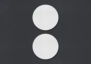 Plain Gray Background Image Drucke: Two round white sheets vertically aligned on a gray background