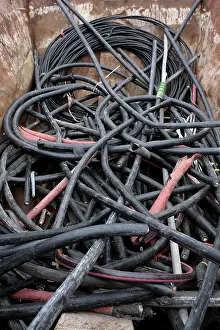 Ecofriendly Waste Disposal Drucke: Rubber hoses in container in the scrapyard