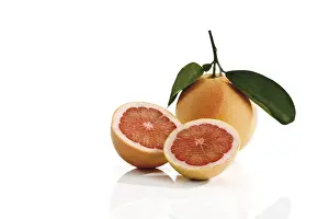 Studio Shot Fruits Drucke: Ruby Red grapefruit with stem and leaves