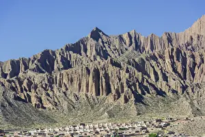 Rugged Mountain Landscape Drucke: Rugged mountain and a planned settlement