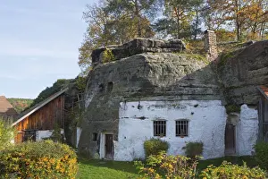 Rocky Cliff Landscape Shot Drucke: A rustic house integrated into a rock face
